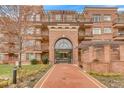 Elegant brick apartment building featuring a grand entrance with a beautifully designed entryway at 2700 E Cherry Creek South Dr # 220, Denver, CO 80209