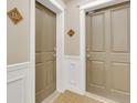 Hallway with neutral-toned walls, stylish doors, and decorative accents, creating a welcoming entrance at 2700 E Cherry Creek South Dr # 220, Denver, CO 80209