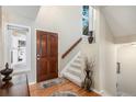 Bright entryway featuring hardwood floors and staircase at 10000 E Yale Ave # 7, Denver, CO 80231