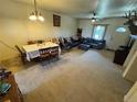 Comfortable living room featuring a dining area, ceiling fan, and neutral-toned carpet at 2874 Rose Hill St, Strasburg, CO 80136