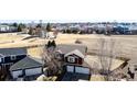 Aerial view of the house with a large backyard and neighborhood playground in the background at 2954 E 108Th Dr, Northglenn, CO 80233