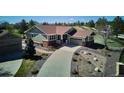 Aerial view of a home showing its driveway, landscaping, and proximity to neighboring houses at 23312 E Chestnut Pl, Aurora, CO 80016