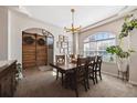 Dining room showcasing a large wood table, arched window, and decorative barn doors at 14953 Akron Ct, Brighton, CO 80602