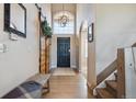 Inviting entryway featuring high ceilings, a modern light fixture and wood accents at 14953 Akron Ct, Brighton, CO 80602