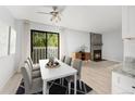 Dining area with modern table and chairs, features a fireplace, and a sliding glass door to the balcony at 580 Vance St # A, Lakewood, CO 80226