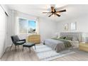 Cozy main bedroom showcases a ceiling fan, a window providing natural light, and neutral decor at 580 Vance St # A, Lakewood, CO 80226