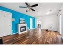 Bright living room with hardwood floors, a modern fireplace, and a ceiling fan for added comfort at 4435 Andes Ct, Denver, CO 80249