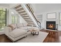 Bright living room featuring a fireplace and staircase, ideal for relaxation at 4802 E Kentucky Ave # E, Denver, CO 80246