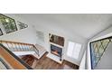 Open-concept living area with fireplace, adjacent to staircase and bright windows at 4802 E Kentucky Ave # E, Denver, CO 80246