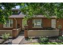 Charming brick townhome featuring a bay window, neat landscaping, and a welcoming front entrance at 3300 W Florida Ave # 51, Denver, CO 80219