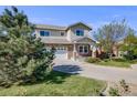 Attractive two-story home featuring stone accents, an attached two-car garage, and a well-maintained lawn at 19294 E Warren Pl, Aurora, CO 80013