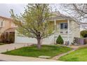Inviting yellow two-story house with a cozy porch, mature landscaping, and ample curb appeal at 20626 Willowbend Ln, Parker, CO 80138