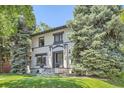 Charming home with black trim, stone stairs, and lush landscaping at 785 Fillmore St, Denver, CO 80206