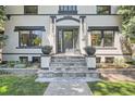 Striking front entrance featuring stone steps, elegant planters, and black trim details at 785 Fillmore St, Denver, CO 80206