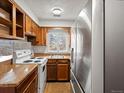 Kitchen featuring stainless steel refrigerator and white appliances at 3398 Wadsworth Blvd, Wheat Ridge, CO 80033