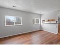 Bright living room with wood floors and natural light from two large windows at 3398 Wadsworth Blvd, Wheat Ridge, CO 80033
