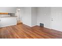 Open floor plan with wood floors leading to an exterior door at 3398 Wadsworth Blvd, Wheat Ridge, CO 80033