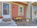 Close-up of front door with sidelight, planters and landscaping at 9747 W Cornell Pl, Lakewood, CO 80227