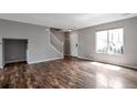 Spacious living room featuring gleaming wood floors, a large window, and ample natural light at 1365 Waxwing Ave, Brighton, CO 80601