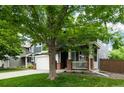 Charming two-story home with a two-car garage and covered front porch with mature trees at 517 Sylvestor Trl, Highlands Ranch, CO 80129