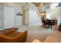 Spacious living room with high ceilings, staircase, and dining area at 517 Sylvestor Trl, Highlands Ranch, CO 80129
