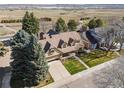 Aerial view of a beautiful suburban home with mature trees and expansive natural surroundings at 5106 S Kenton Way, Greenwood Village, CO 80111