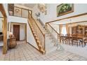 Grand foyer features high ceilings, chandelier, open staircase, and adjoining dining room at 5106 S Kenton Way, Greenwood Village, CO 80111