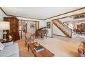 Cozy living room featuring wood trim, piano, vintage furniture and a staircase at 5106 S Kenton Way, Greenwood Village, CO 80111