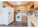Well-lit kitchen showcasing a white refrigerator and oven, plus ample cabinet space at 775 S Alton Way # 3C, Denver, CO 80247