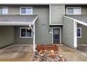 Exterior of the townhome with grey siding and a rock garden in front of the inviting front door at 2976 Eagle Way, Boulder, CO 80301
