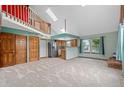 Spacious living room with vaulted ceilings, a loft area, and large windows that provide natural light at 3300 W Florida Ave # 36, Denver, CO 80219