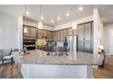 Modern kitchen featuring stainless steel appliances, granite countertops, and ample cabinet space at 811 W 128Th Pl, Westminster, CO 80234