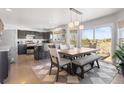 Kitchen with a dining table, bar seating, and sliding glass doors to the deck at 16135 Rock Crystal Dr, Parker, CO 80134