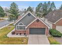 Charming home featuring mixed siding, brick accents, and a two-car garage at 2295 S Depew St, Denver, CO 80227
