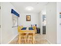 Bright dining area features a wooden table with four chairs at 3600 S Pierce St # 7-104, Denver, CO 80235