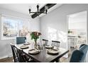 Elegant dining room with a wooden table set for six and plenty of natural light at 7307 S Birch St, Centennial, CO 80122