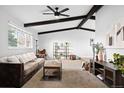 Spacious living room with exposed wood beams, large windows, and modern furnishings at 7307 S Birch St, Centennial, CO 80122