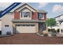 Under Construction: Charming two-story home with a brick driveway, stone accents, a two-car garage and blossoming landscaping at 1170 Sugarloaf Ln, Erie, CO 80516