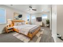 Bright bedroom featuring a ceiling fan, modern decor, soft rug, and minimalist bedside tables at 339 Rocking Chair Dr, Berthoud, CO 80513