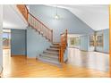 Bright entryway featuring a staircase with wooden banister and hardwood floors leading to a spacious living area at 9983 Cottoncreek Dr, Highlands Ranch, CO 80130