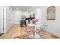 View of a dining area adjacent to the kitchen, featuring clear chairs, and a round table at 2851 W 52Nd Ave # 404, Denver, CO 80221