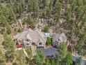 Beautiful exterior view of a house nestled amongst the trees in a mountainous location at 4158 Wild Flower Ct, Evergreen, CO 80439