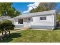 Charming single-story home with a landscaped front yard and inviting walkway at 1211 S Zuni St, Denver, CO 80223