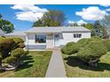 Charming single-story home with a landscaped front yard and inviting walkway at 1211 S Zuni St, Denver, CO 80223