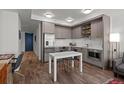 A stylish kitchen is featured with stainless steel appliances, custom cabinets, and a dining area at 1750 Wewatta St # 605, Denver, CO 80202