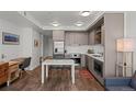 A stylish kitchen is featured with stainless steel appliances, custom cabinets, and a dining area at 1750 Wewatta St # 605, Denver, CO 80202