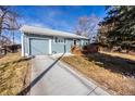 Well-kept home with a spacious driveway and a detached garage at 705 Kenton St, Aurora, CO 80010