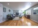 Bright living room with hardwood floors and large windows at 705 Kenton St, Aurora, CO 80010