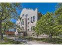 Elegant apartment building surrounded by mature trees and lush landscaping at 108 W Byers Pl # G1, Denver, CO 80223