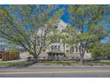 Handsome brick apartment building framed by mature trees on a beautiful day at 108 W Byers Pl # G1, Denver, CO 80223